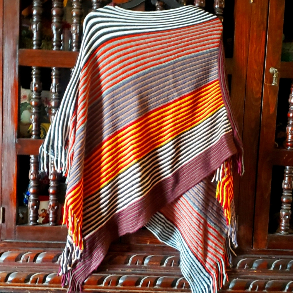 Knit poncho with fringed edges